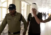 पेपर लीक मामले के आरोपी को पुलिस हिरासत में ले जाती टीम